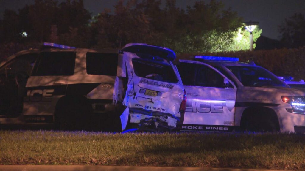 Car slams into marked police vehicle