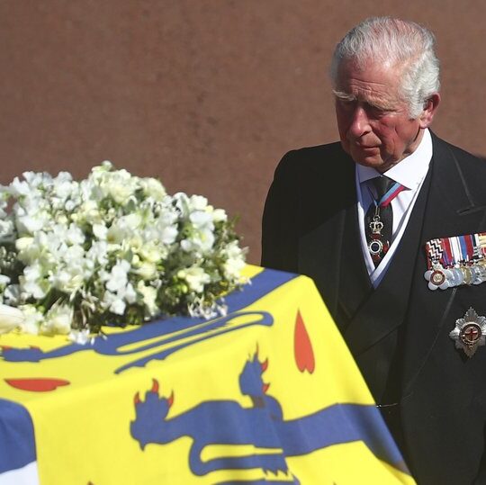 Prince Philip is laid to rest as somber queen sits alone